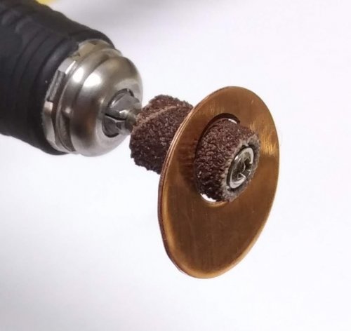 Judy Larson's Disc Cutter Basics and How to Make Metal Washers - Version 2 when no center positioning tool or doming punch is available:, General Education, Tools, Use a flex shaft or a Dremel tool with a sanding drum